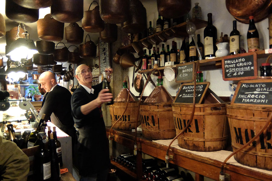 Cantina Do Mori interior with wine barrels and staff