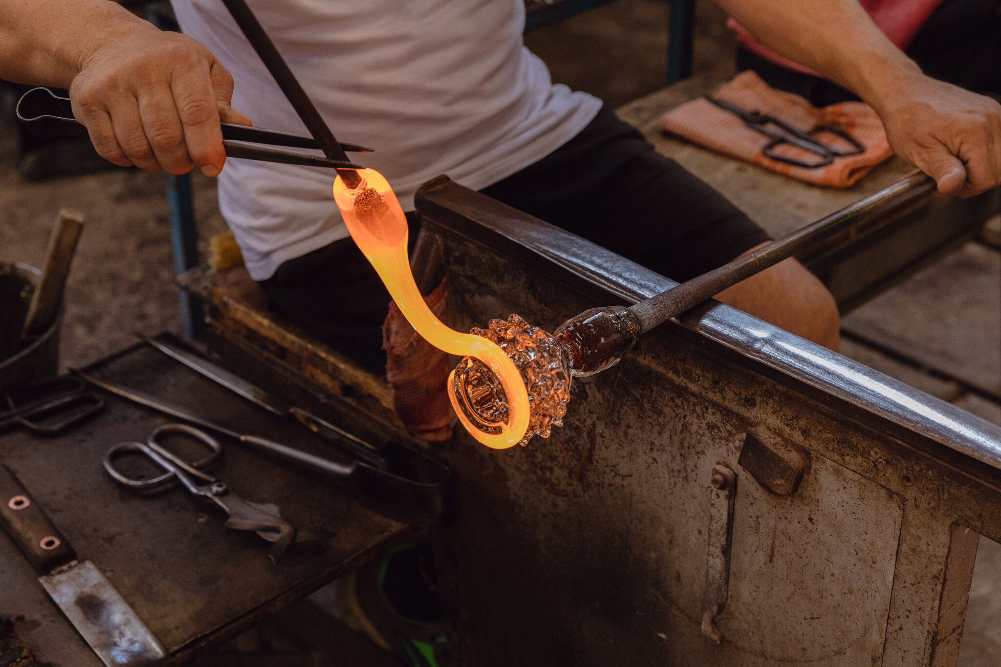 Master artisan shaping molten Murano glass