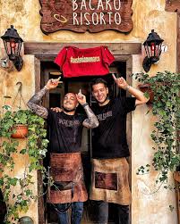 Two people standing outside Bacaro Risorto in Venice